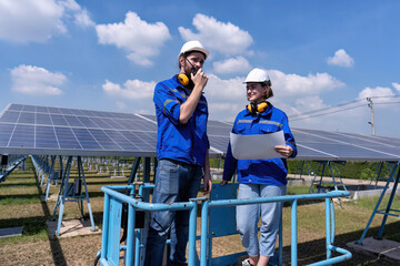 Maintenance engineer at solar farm stand on scissor lift inspection solar panel and radio report