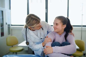 Close-up of doctor consoling teenage girl in her ambulance office.
