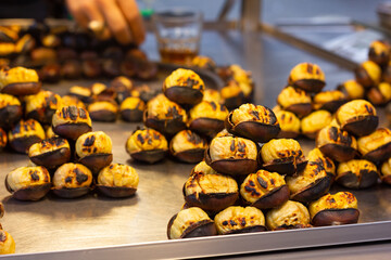 Roasted chestnuts piled up on street stall in Istanbul, Turkey. Fast food seasonal snack concept