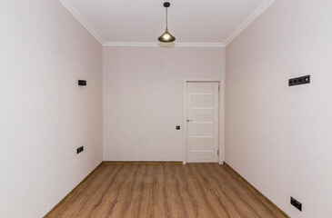 Fototapeta na wymiar Empty room in light colors after renovation with closed door