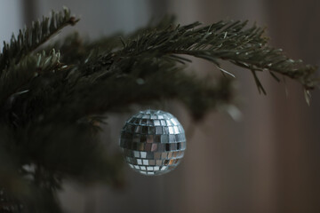 Christmas composition. New Year background - baubles and branch of spruce tree. Christmas decoration hanging on tree