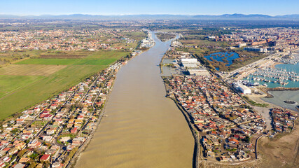 Aerial view of the Tiber River estuary in the Tyrrhenian Sea. It is located in the municipality of...