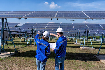 Maintenance engineer at solar farm looking drawing discuss on expansion upgrade electricity plant