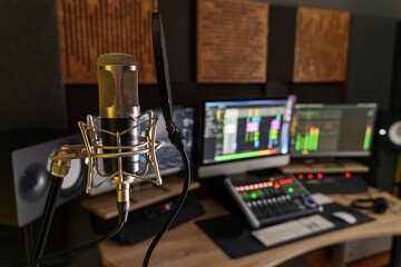 Professional microphone in a small music sound production studio workstation - audio video technology production concept