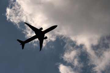 Airplane flying over blue sky and clouds