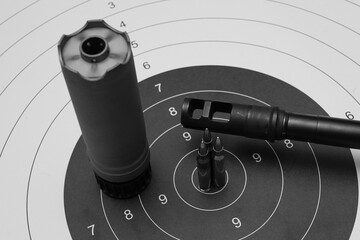Rifle shooting, target, silencer, rifle barrel with muzzle brake and caliber 223 cartridges.