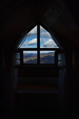 Fototapeta na wymiar Wooden house inside with big opened windows. Beautiful view on mountains