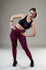 Confident plus size woman stretching before workout