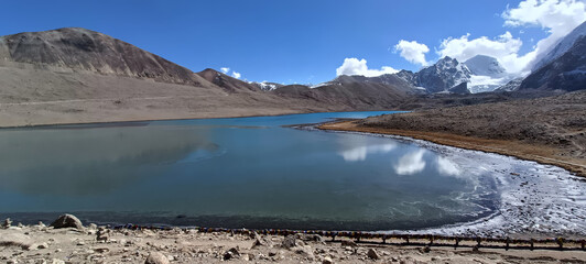 Panoramic landscape view of Gurudongmar Lake, one of the highest lakes in the world and a famous tourist attraction, located in North Sikkim, India