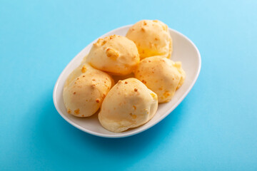 Brazilian snack pao de queijo cheese bread on white dish