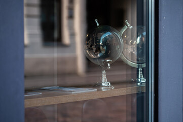 glass globe on table, view through window with street reflections, copy space