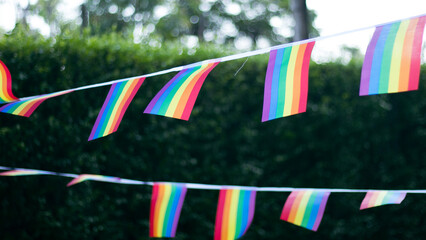 Obraz premium Closeup of gay PRIDE with heart shaped rainbow flag on wrist. Rainbow tattoo. LGBTQ pride month symbol. Equal rights.