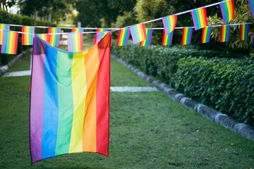 Closeup of gay PRIDE with heart shaped rainbow flag on wrist. Rainbow tattoo. LGBTQ pride month symbol. Equal rights.