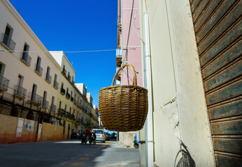 View of the street with delivery basket from balcony.