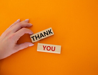 Start now symbol. Wooden blocks with words Start now. Beautiful orange background. Businessman hand. Business and Start now concept. Copy space.