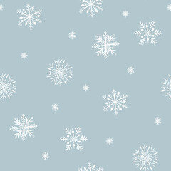 Winter seamless pattern of snowflakes. White snowflakes on gray background.