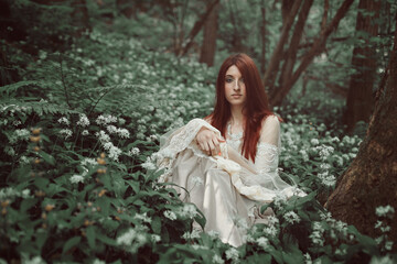 Beautiful red haired girl in secret forest - 553257230