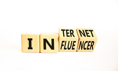 Internet influencer symbol. Concept word Internet influencer on wooden cubes. Beautiful white table white background. Business internet influencer concept. Copy space.