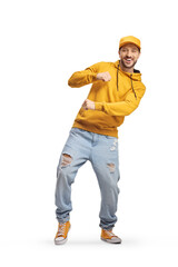 Young man in a hoodie and cap dancing