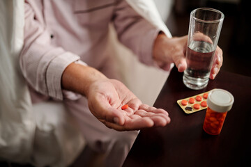 Sick Elderly Man Taking Pills