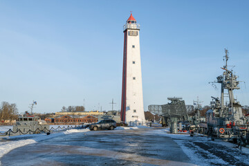 Old wooden lighthouse on the pier on a January afternoon. Middle harbor. Kronstadt
