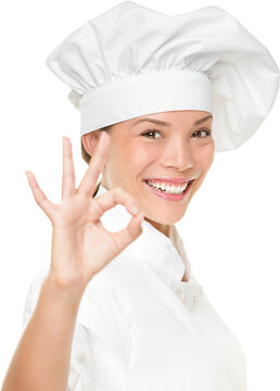 Chef baker or cook showing ok hand sign for perfection. Woman chef happy and proud. Portrait of cook wearing chefs hat isolated cutout PNG on transparent background. Asian Caucasian female model.