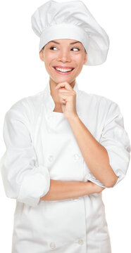 Chef thinking looking smiling and happy to the side. Woman chef, cook or baker in chef uniform and hat. Young Asian female isolated cutout PNG on transparent background.