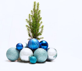 christmas balls on white. A lot of Christmas balls to decorate the Christmas tree, next to the tree.