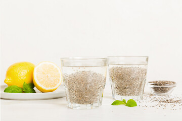 Healthy breakfast or morning with chia seeds lemon and mint on table background, vegetarian food, diet and health concept. Chia pudding with lemon and mint