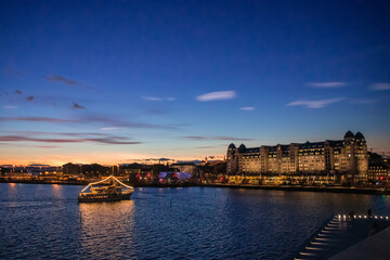 Fototapeta na wymiar City of Oslo Norway in the Evening with Sunset, Sea, Historical buildings and Christmas decorations
