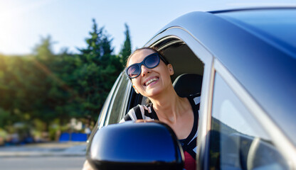 Beautiful young woman driving a car.