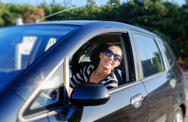 Beautiful young woman driving a car.