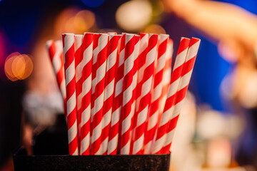 straws with red and white stripes in a bunch isolated on blury background.