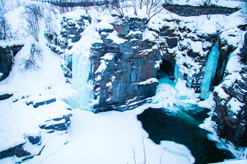 Frozen Waterfall Landscape in Abisko National Park, Sweden in Winter