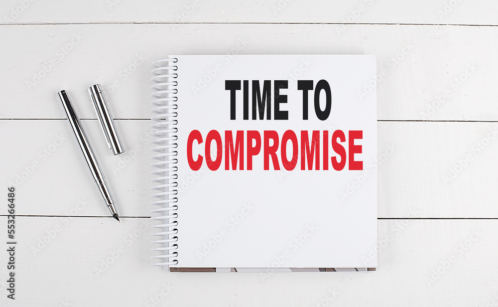 Poster time to compromise text written on notebook on the wooden background