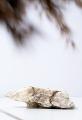 A minimalistic scene of stone marble podium on white background, for natural cosmetics
