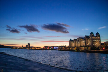Fototapeta premium City of Oslo Norway in the Evening with Sunset, Sea, Historical buildings and Christmas decorations