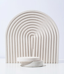 Fototapeta premium A minimalistic scene of a gypsum podium with stones on white background, for natural cosmetics