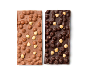 Milk and dark chocolate with nuts on a white background top view.