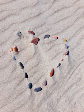 Heart of stones stacked on the sands.