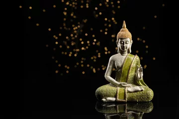 Foto op Plexiglas Buddha statue in meditation with lights on black background with copy space. © Miguel Tamayo 