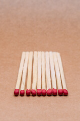 New unlit wooden matchsticks orderly aligned on natural brown background