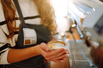 Barista waitress holding a white-hot coffee cup. Food and drink concept.