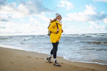 Happy tourist in a yellow jacket  enjoying sea landscape. Travelling, lifestyle, adventure.