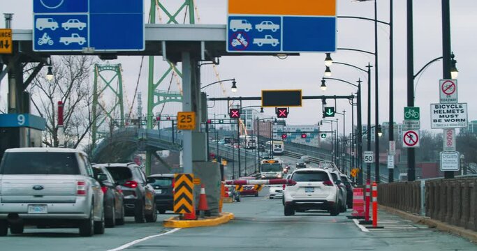 Time lapse of cars entering the toll bridge in Halifax city Canada. Cars cross a toll bridge to get into the down tout of Halifax.