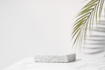 Porous pedestal on white table for beauty cosmetic product presentation. Bathroom shelf mockup. - obrazy, fototapety, plakaty