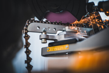 Sharpening motor chain or chainsaw chain with the use of a motorized grinder. Professional...