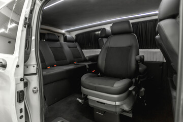 comfortable passenger bus interior with upholstered seats; individual transfer for a group of people; conversion of the interior of a truck; 