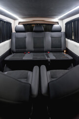 comfortable passenger bus interior with upholstered seats; individual transfer for a group of people; conversion of the interior of a truck; 