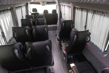 comfortable passenger bus interior with upholstered seats; individual transfer for a group of...